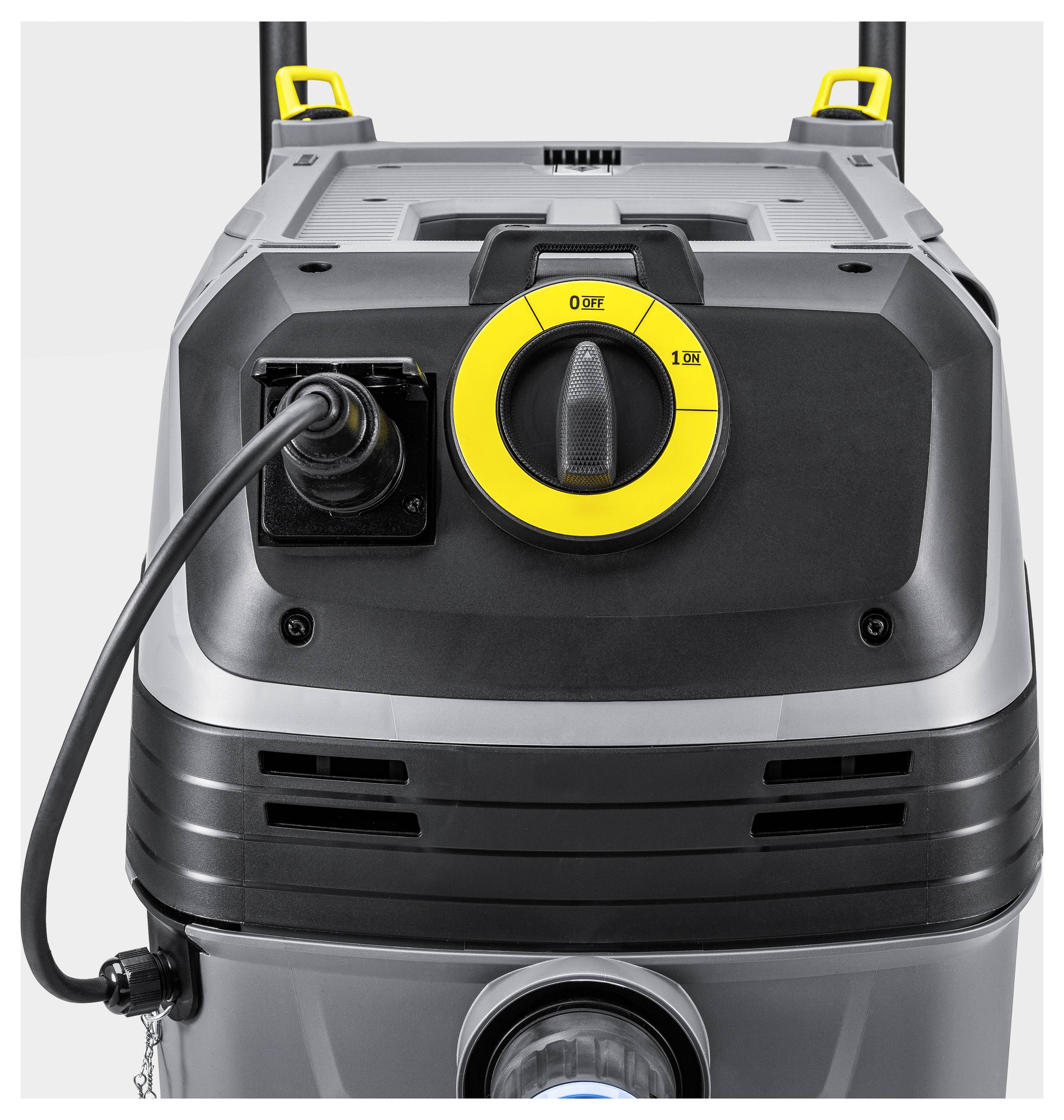 The image shows the control panel of an industrial cleaning machine with a prominent yellow dial labeled '0 OFF - 1 ON' and a large power cable plugged in.