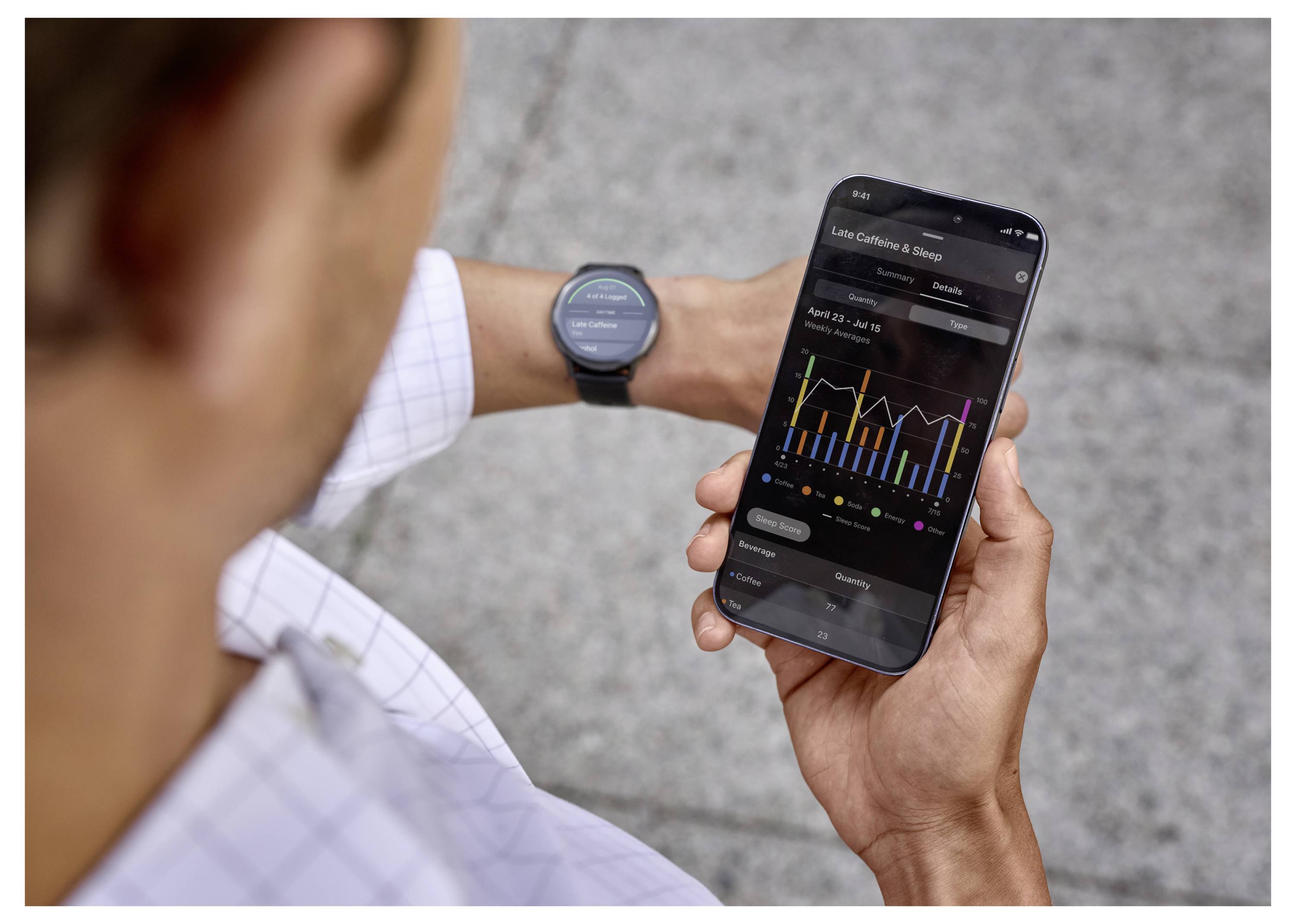 A person checks fitness data on a smartphone, showing various graphs and statistics, wearing a smartwatch, on a textured surface.
