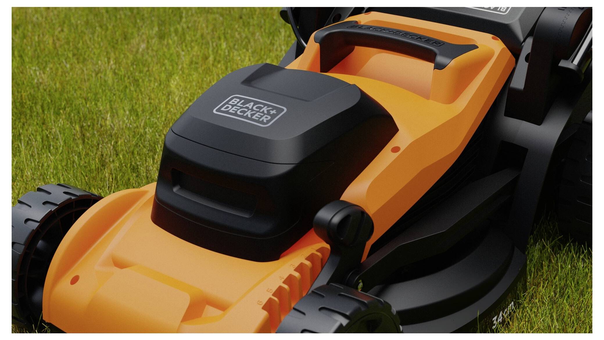 An orange and black lawn mower on a grassy lawn, featuring a handle and wheels.