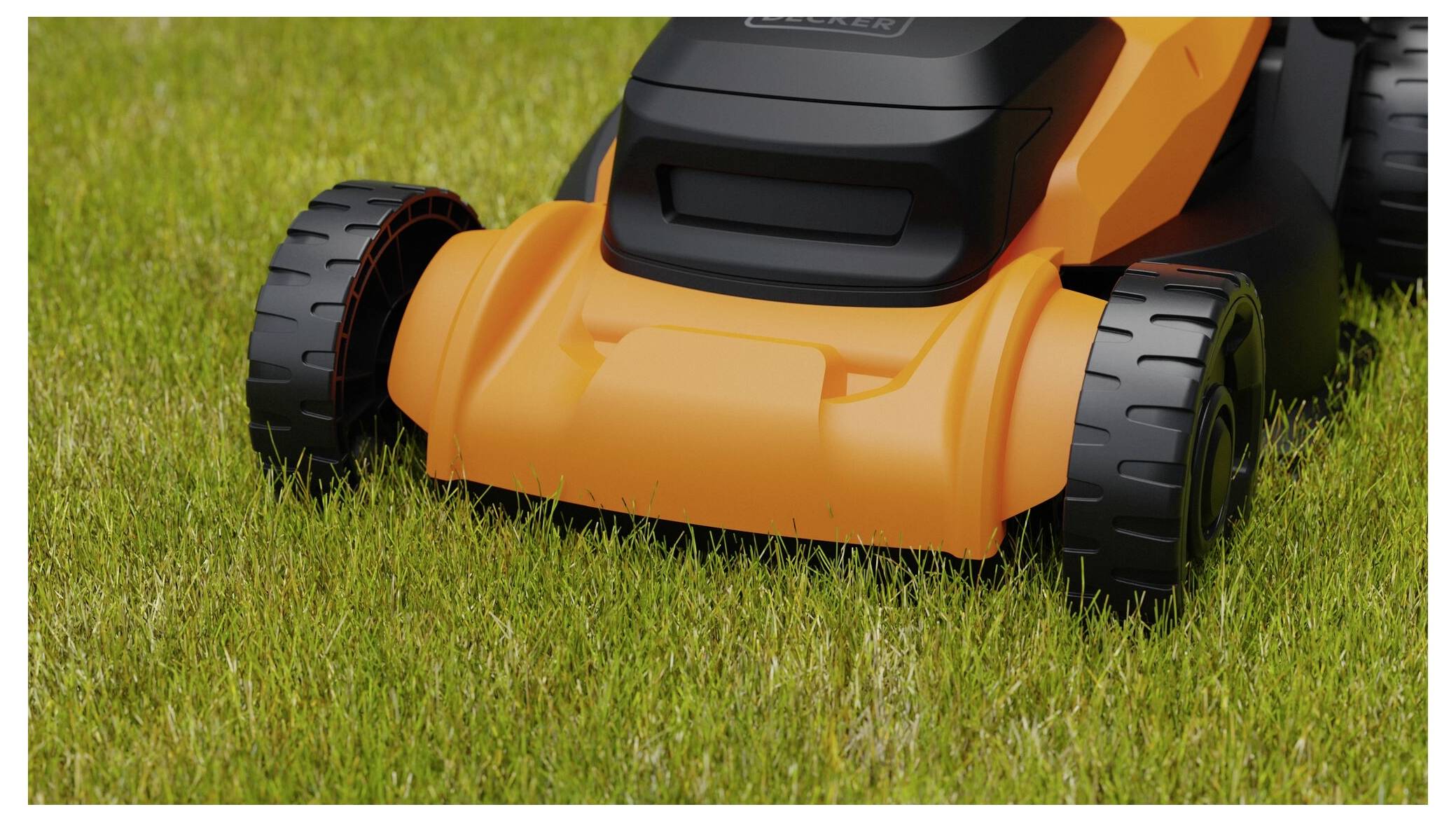 'A close-up of an orange and black lawn mower positioned on green grass, highlighting its wheels and body.'