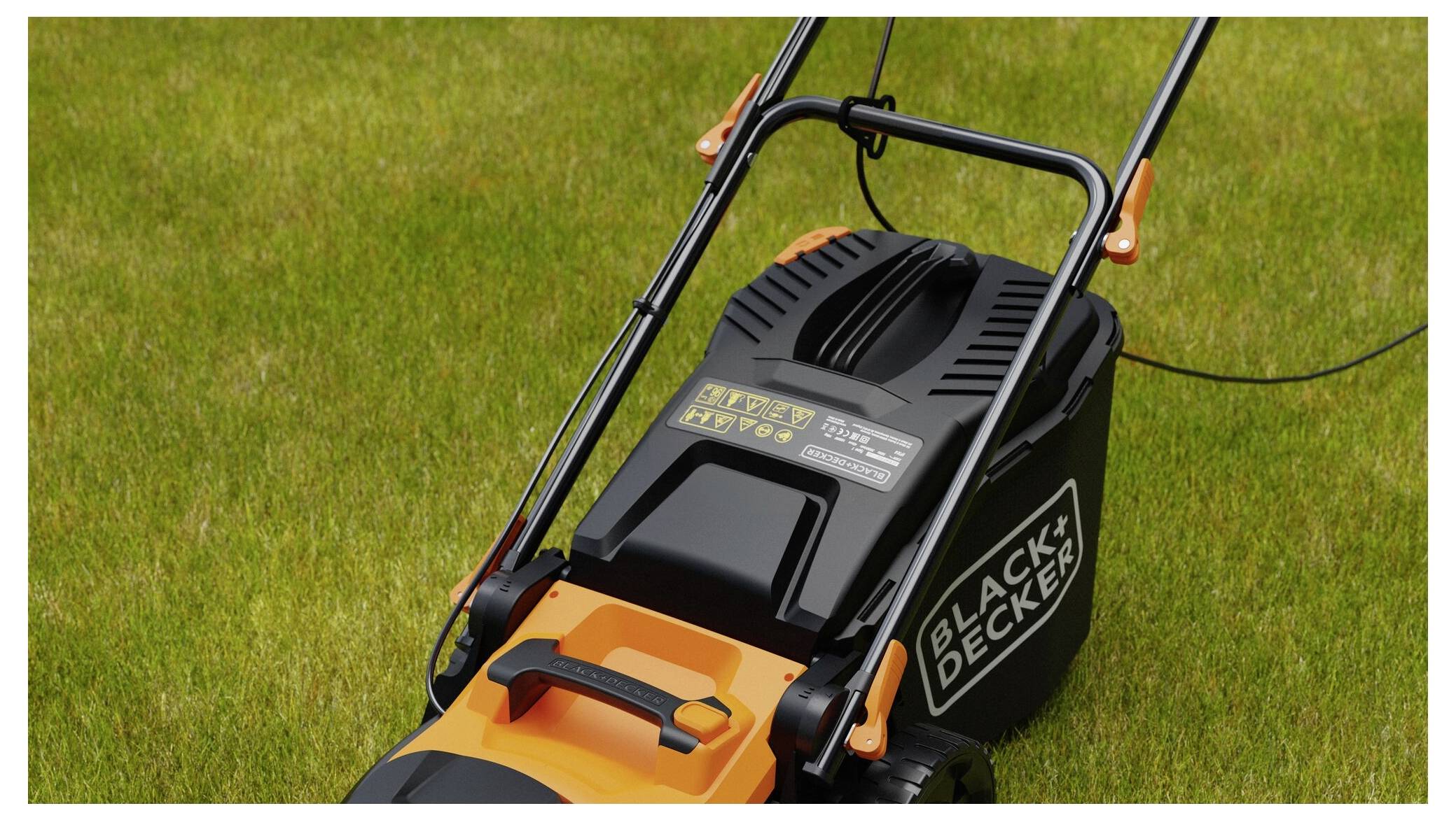 'A BLACK+DECKER lawnmower on freshly cut grass, showing the handle and upper part of the mower with visible brand text.'
