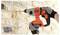A person wearing gloves uses an orange and black power drill to make a hole in a brick wall.