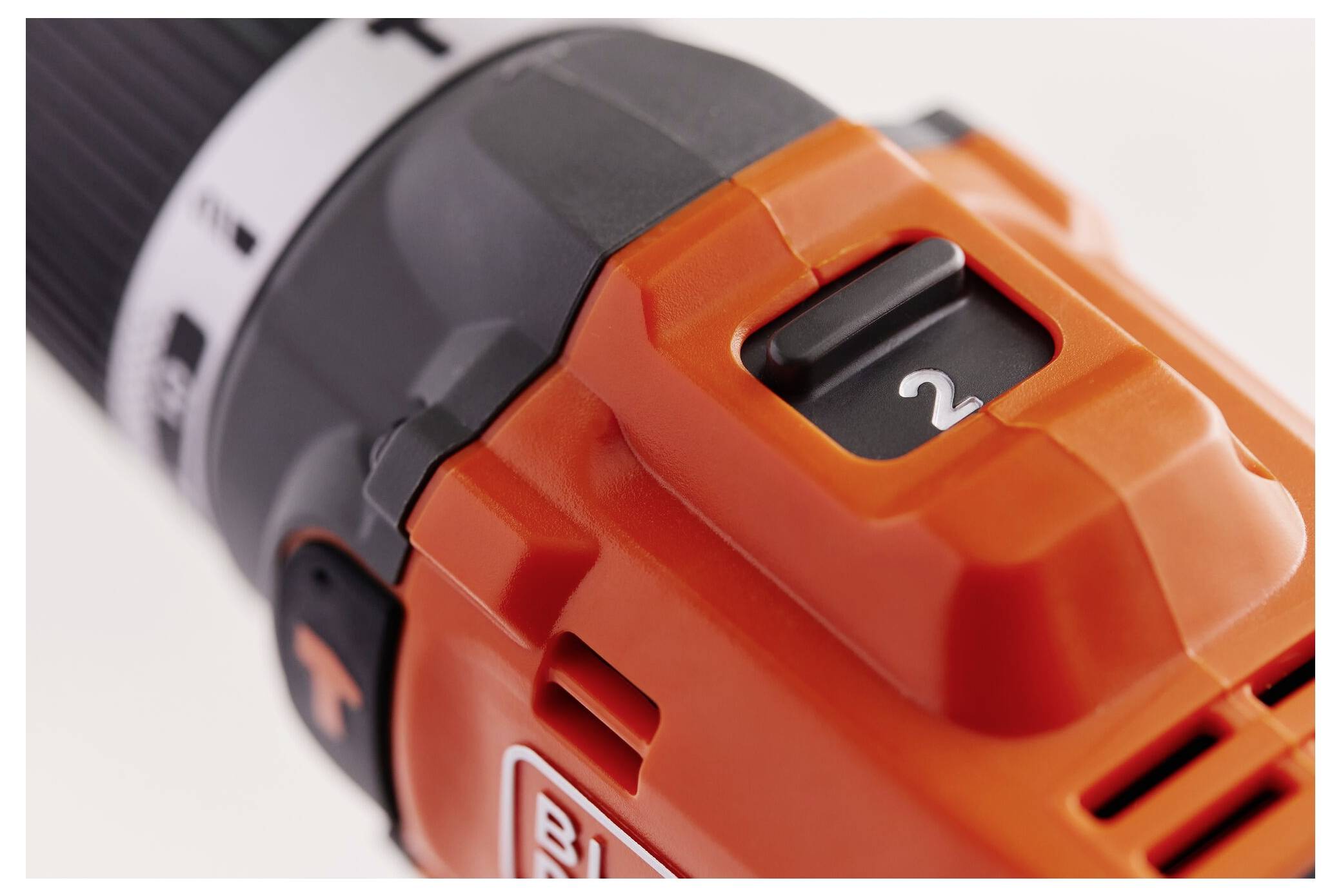 Close-up of a power drill showcasing the speed setting '2'. The drill is primarily orange with black and gray accents.