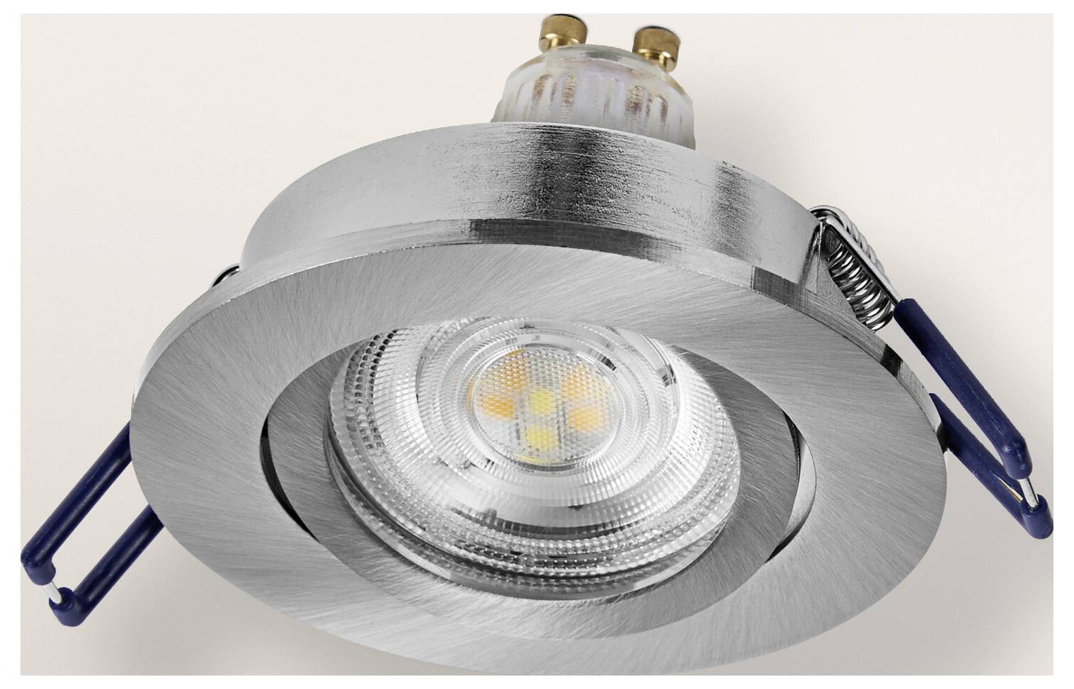 Recessed ceiling spotlight with a silver metallic finish and visible LED bulb, designed for modern interior lighting.