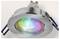 A metallic recessed ceiling light with a circular design, emitting a colorful glow in blue, green, and pink hues from its glass lens.