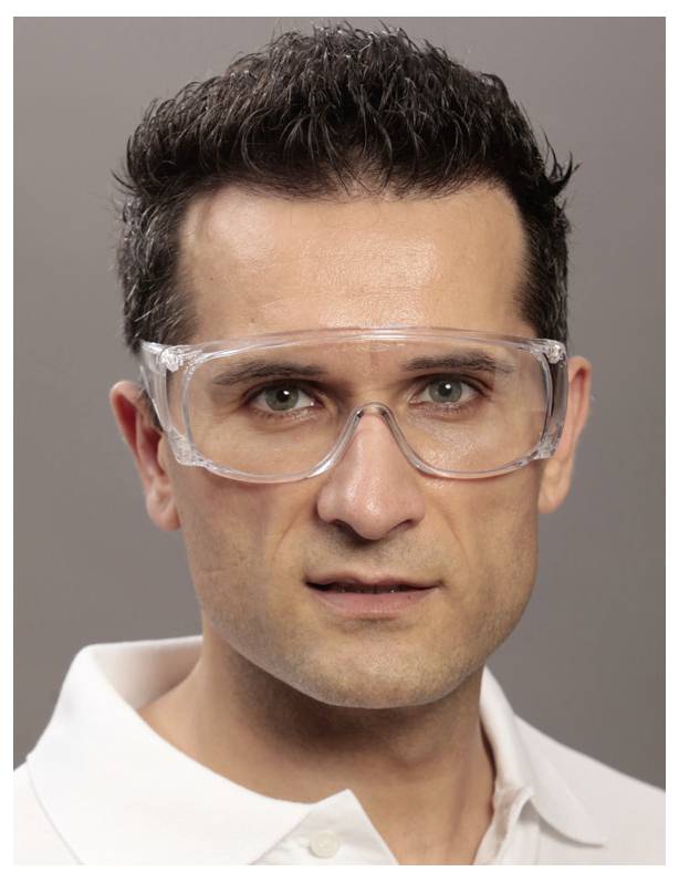 A person wearing safety goggles, looking directly at the camera. The background is plain, suggesting a focus on the protective eyewear.