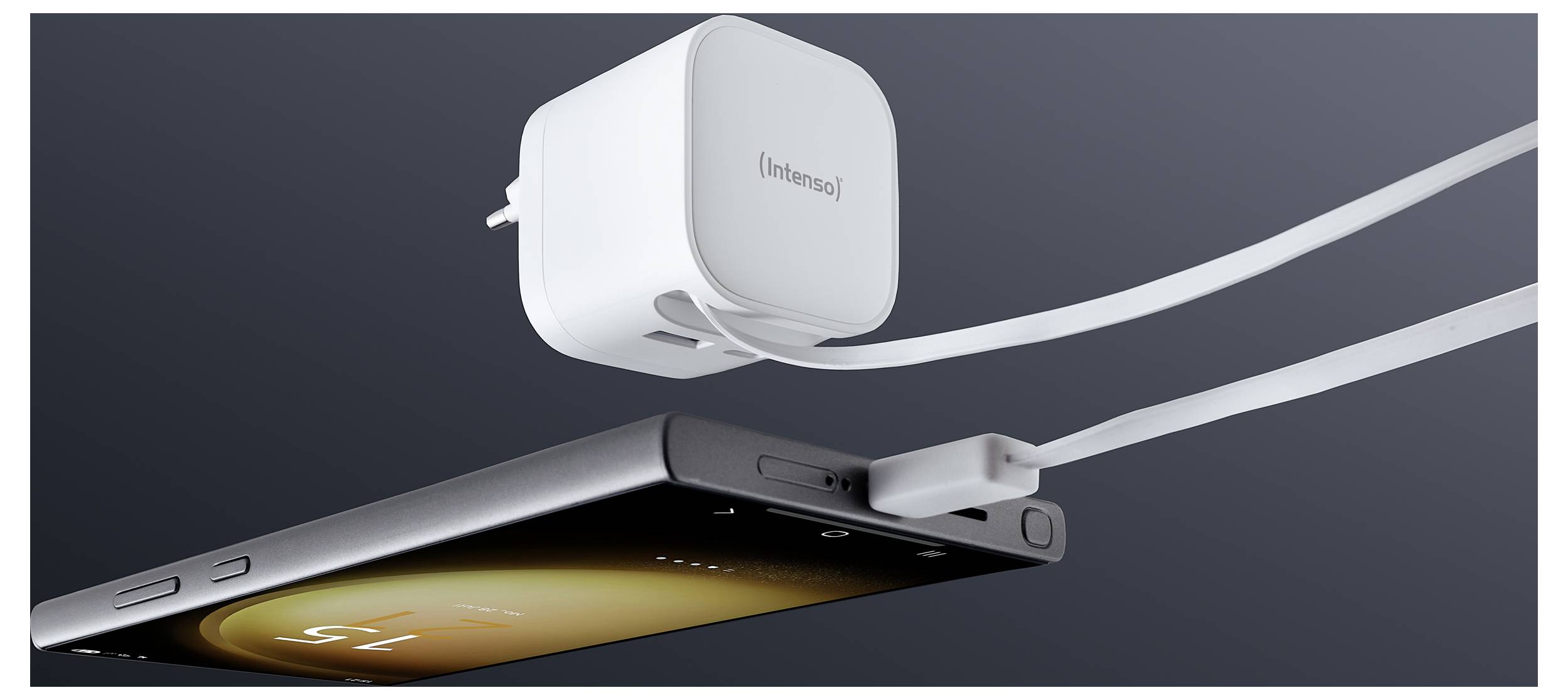 A smartphone connected to a white charging adapter with two attached cables, showing the phone charging on a dark background.