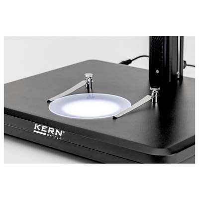 A close-up of a KERN Optics device, featuring an illuminated circular platform with two adjustable metal arms, used for precise measurements.