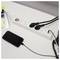 'Phone charging via a power strip on a desk with other devices plugged in, indicating a workspace setup.'