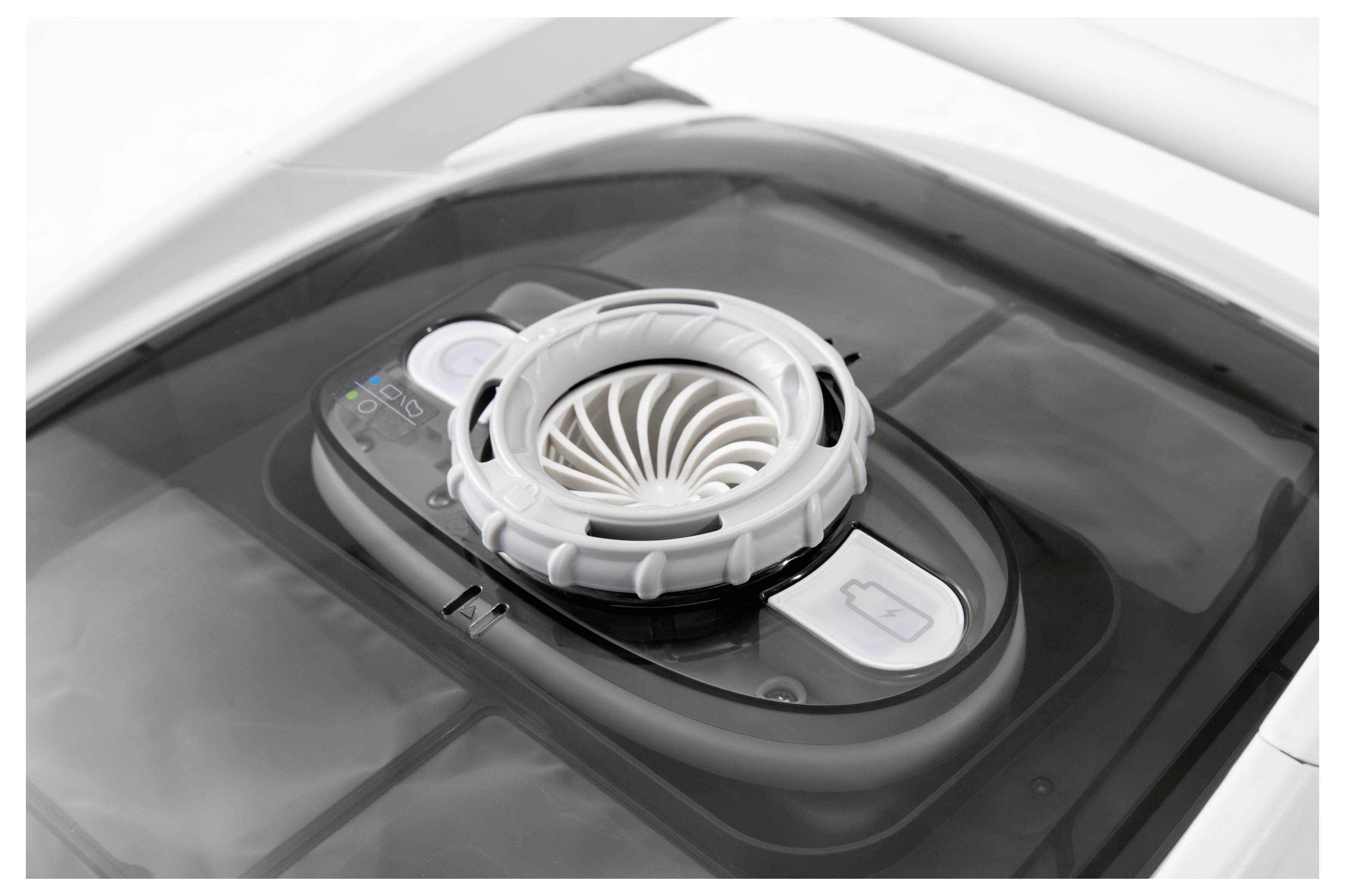 A black and white air mover with a circular vent and control panel. It appears to be on the roof of a vehicle.