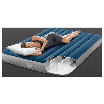 A woman sleeps on a blue and gray inflatable air mattress, which features an interior structural view highlighting its support chambers.
