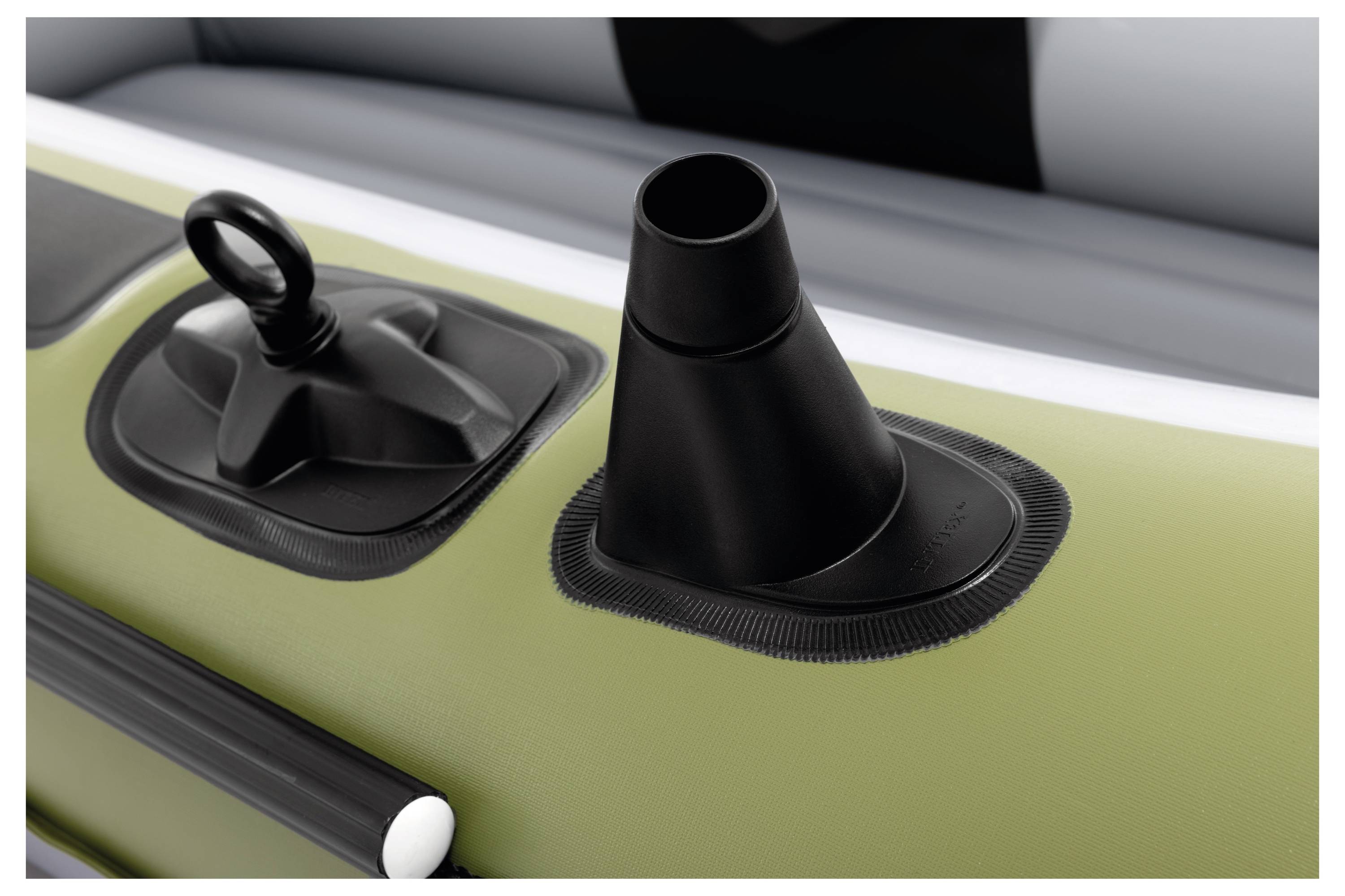 The image shows an air valve on an inflatable raft, featuring a black, conical cap and an adjacent handle for secure closure and inflation.