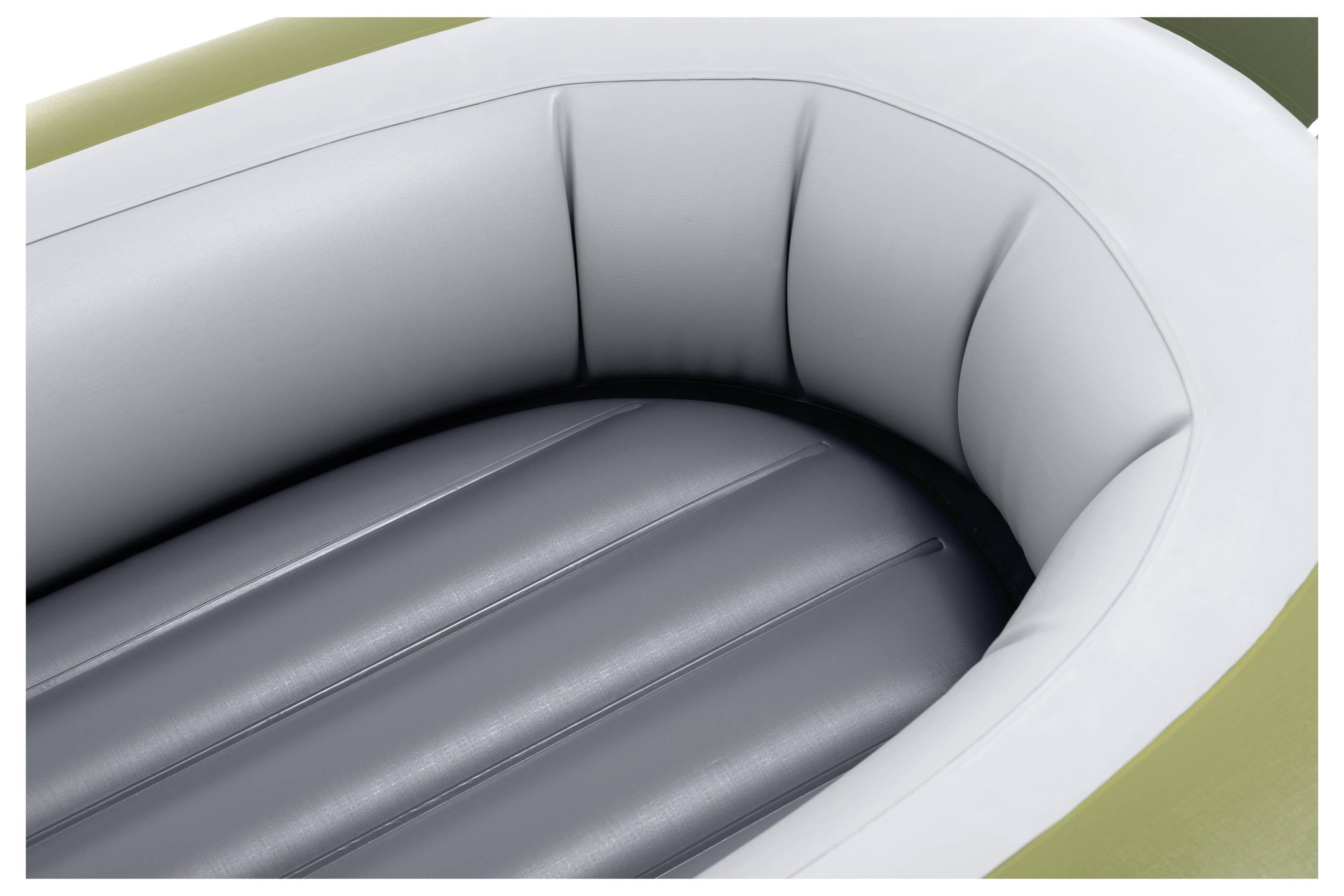 The image shows a close-up of an inflatable raft, focusing on its interior with grey inflatable sections and a white and green outer rim.
