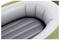 The image shows a close-up of an inflatable raft, focusing on its interior with grey inflatable sections and a white and green outer rim.