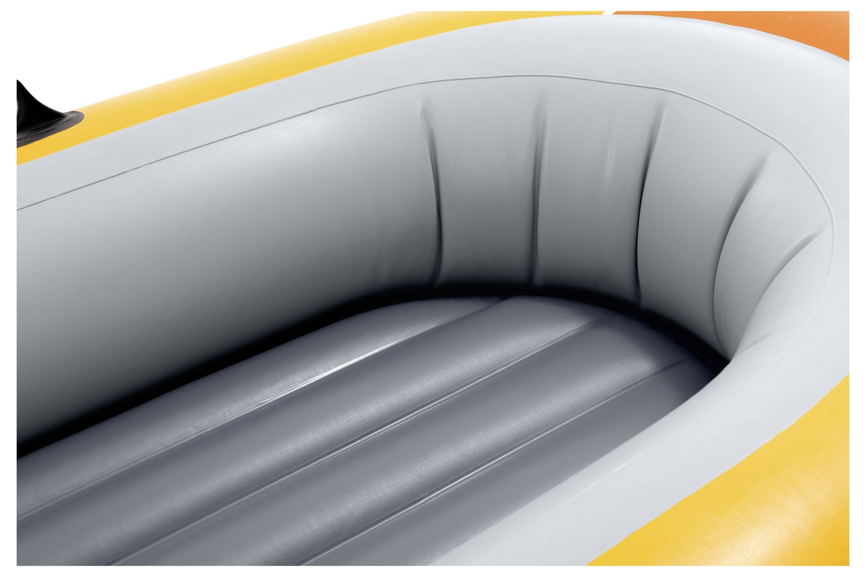 A close-up of an inflatable boat interior, featuring gray cushioned seats and orange edging, suggesting comfort and buoyancy.
