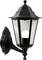 Black outdoor wall lantern with a classic design, featuring a glass enclosure and visible light bulb inside, mounted on a decorative wall bracket.