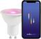 A smartphone displays the 'nordlux smart' app next to a smart bulb emitting pink light, showing smart home lighting control functionality.