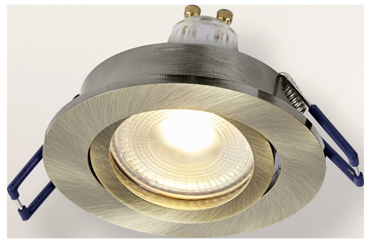 A recessed ceiling light fixture with a brushed metal finish and a visible bulb, surrounded by two mounting clips on either side.
