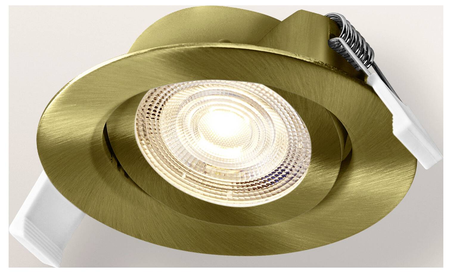 A recessed, gold-colored spotlight with a modern design features a textured surface and spring clips for ceiling installation.