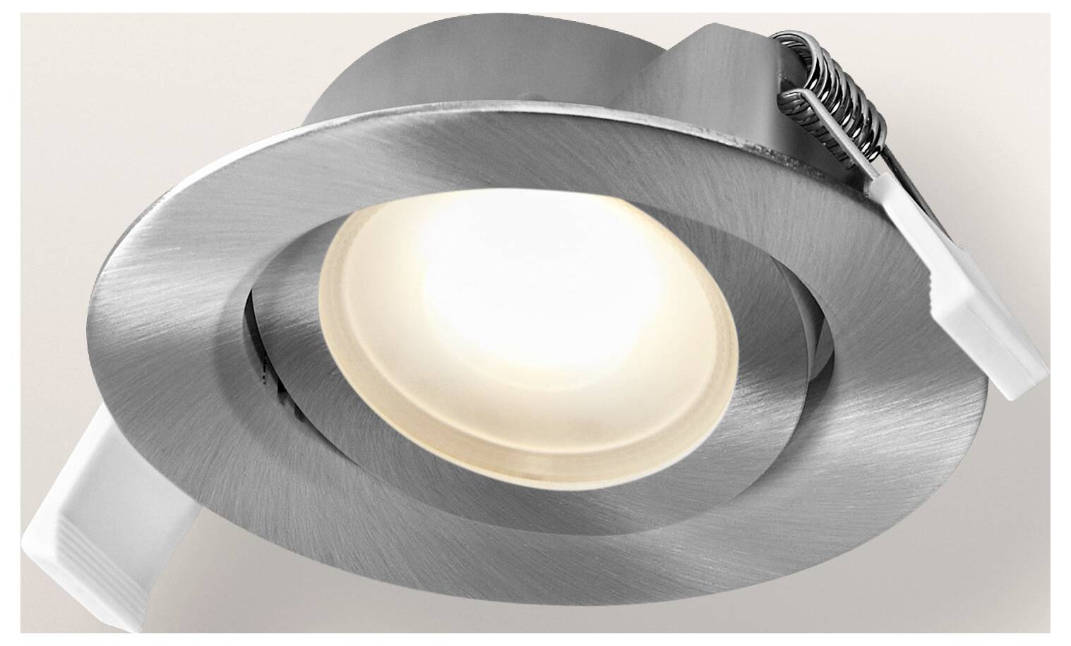 Silver recessed ceiling light fixture with a round design and attached spring clips for installation.