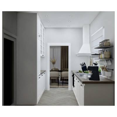 A modern kitchen with white cabinets and wooden countertops, featuring a coffee maker and fruit bowl. Leads to a dining room with chairs.