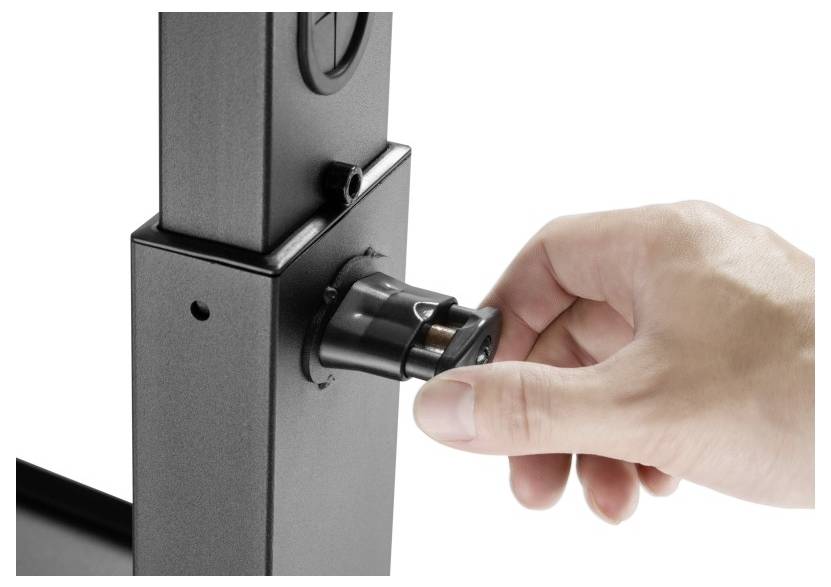 A hand adjusting a metal cylinder attached to a vertical black metal frame.