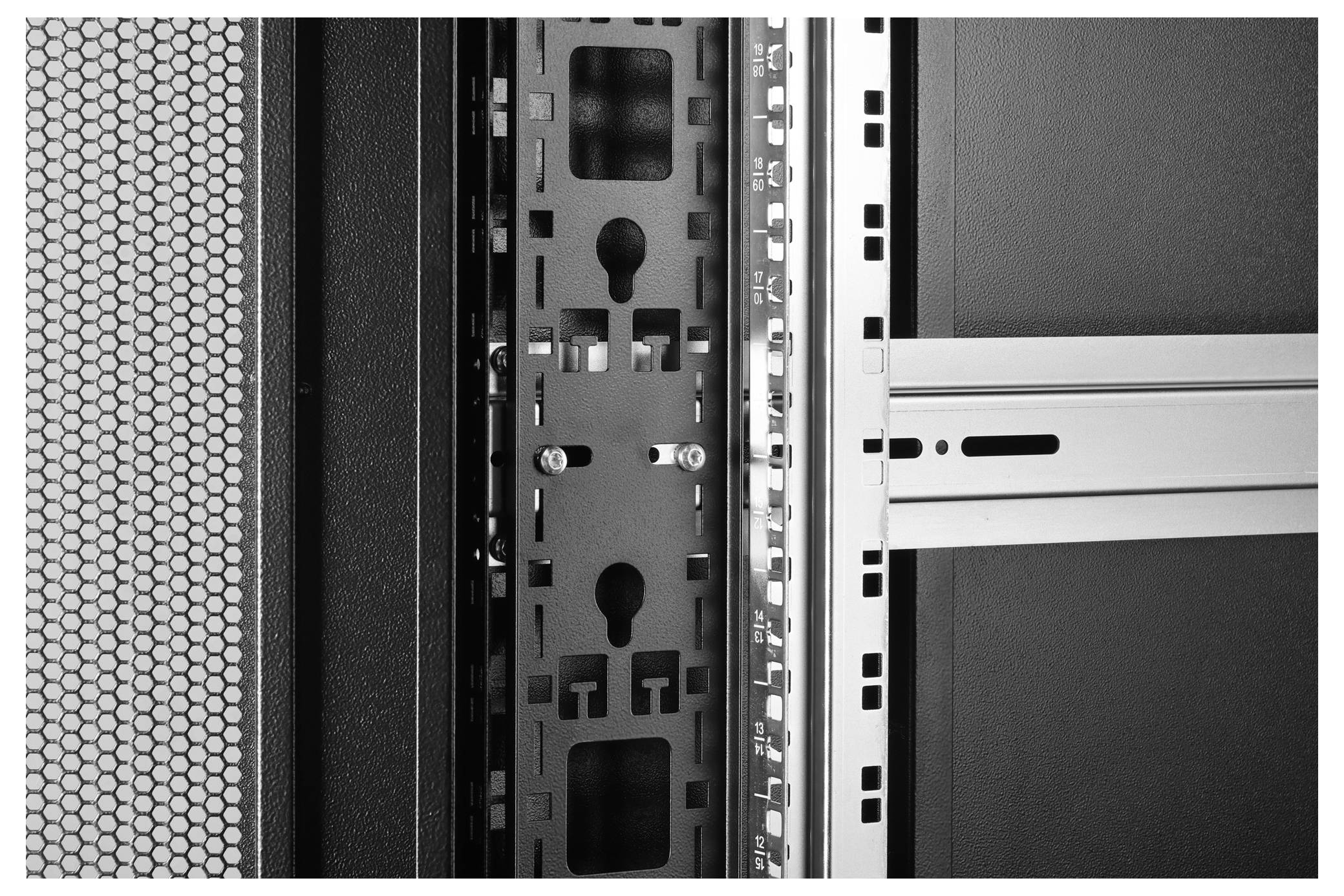 Close-up of a computer server rack with perforated panel and metal framework, highlighting structural details and ventilation design.