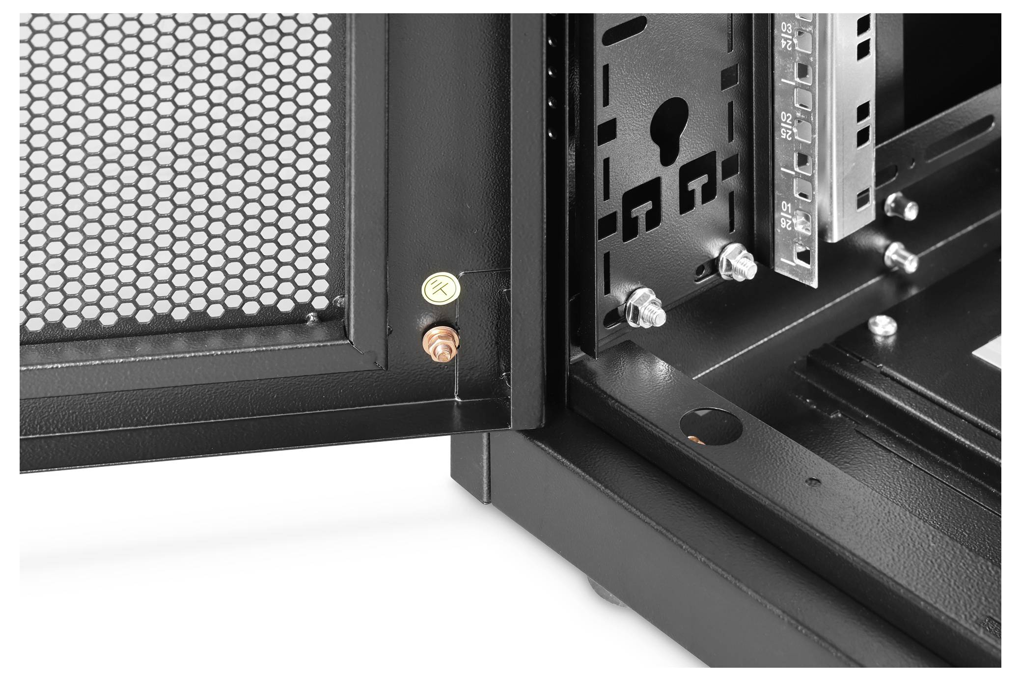 Close-up of a computer case's interior, showing a grid-patterned side panel and two screw mounts, one red-colored and one yellow.
