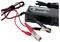 Battery charger with red and black alligator clips connected.