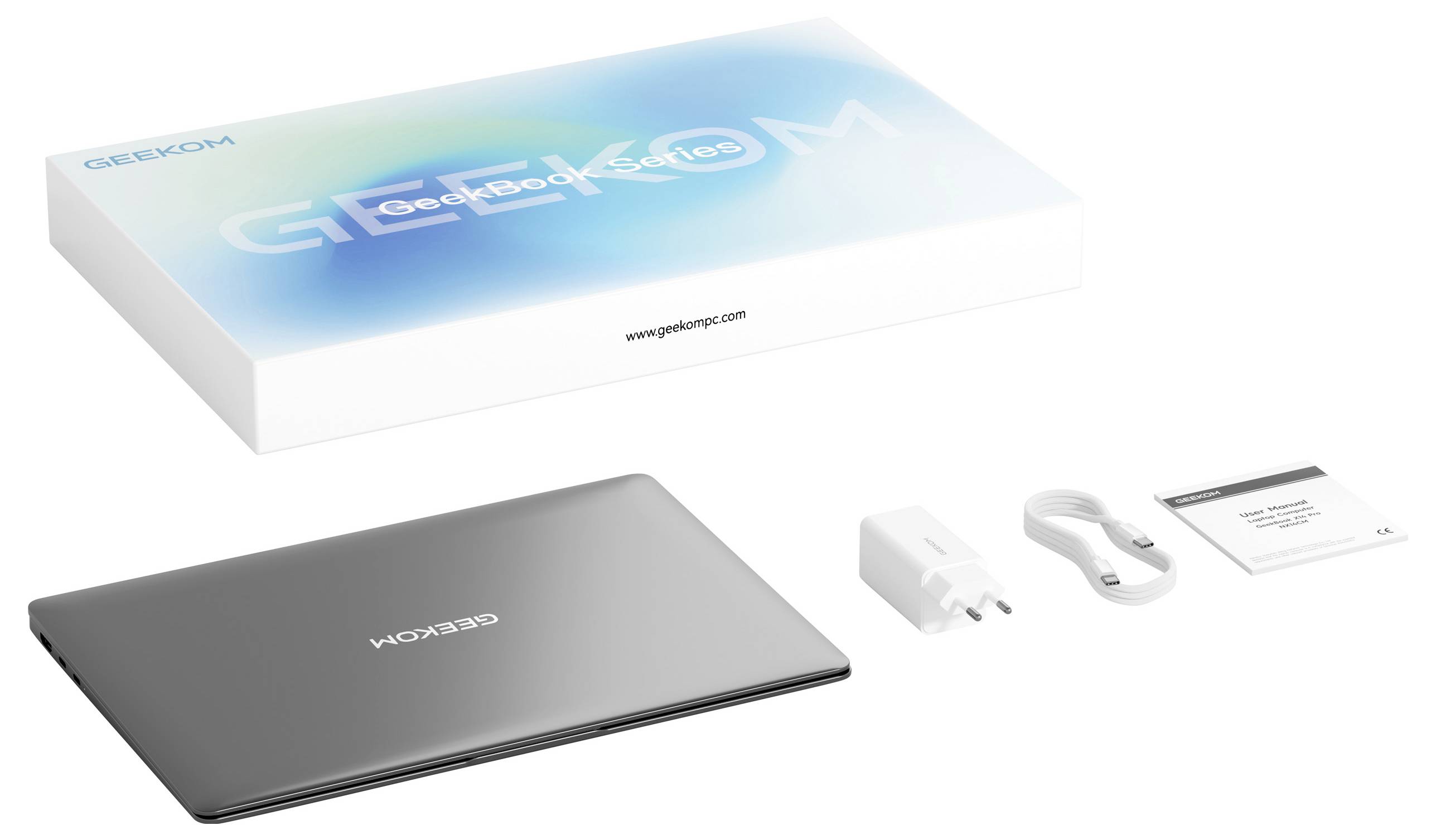 A Geekom laptop with power adapter, USB cable, and user manual shown alongside the product packaging displaying the Geekom logo.