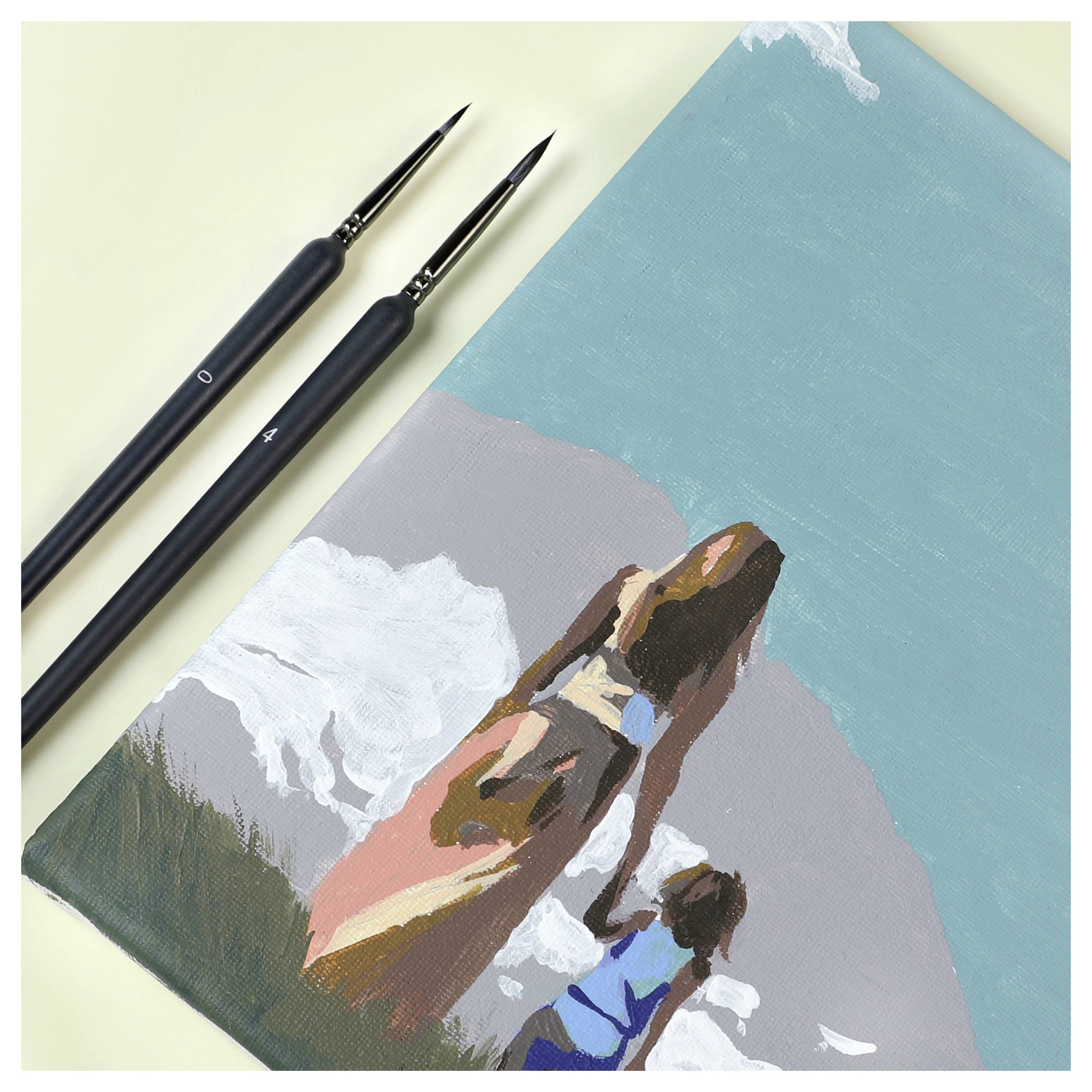 A painting depicts a woman in a dress holding a child's hand, standing near waves. Two brushes lie beside the canvas.