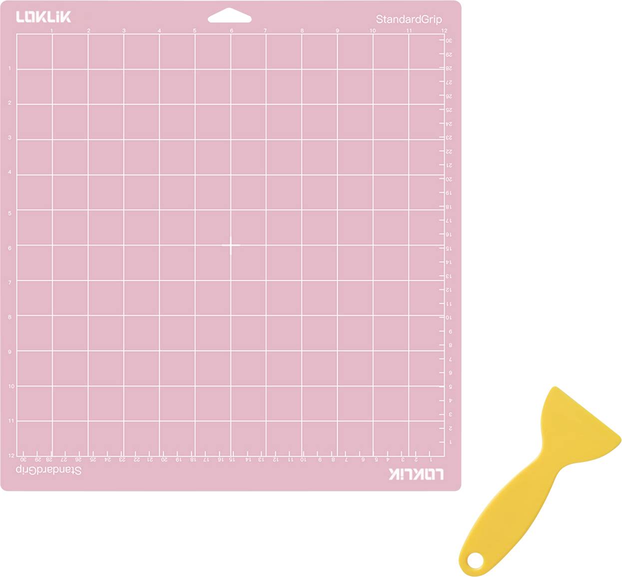 'A pink cutting mat with a grid layout and a yellow scraper tool placed beside it for crafting or DIY projects.'