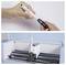 A person inserts a Cricut pen into a machine holder, preparing it for use. The pen is positioned in a light blue Cricut machine.