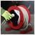 A person wearing green gloves is retracting a white extension cord into a red cord reel on a concrete floor.