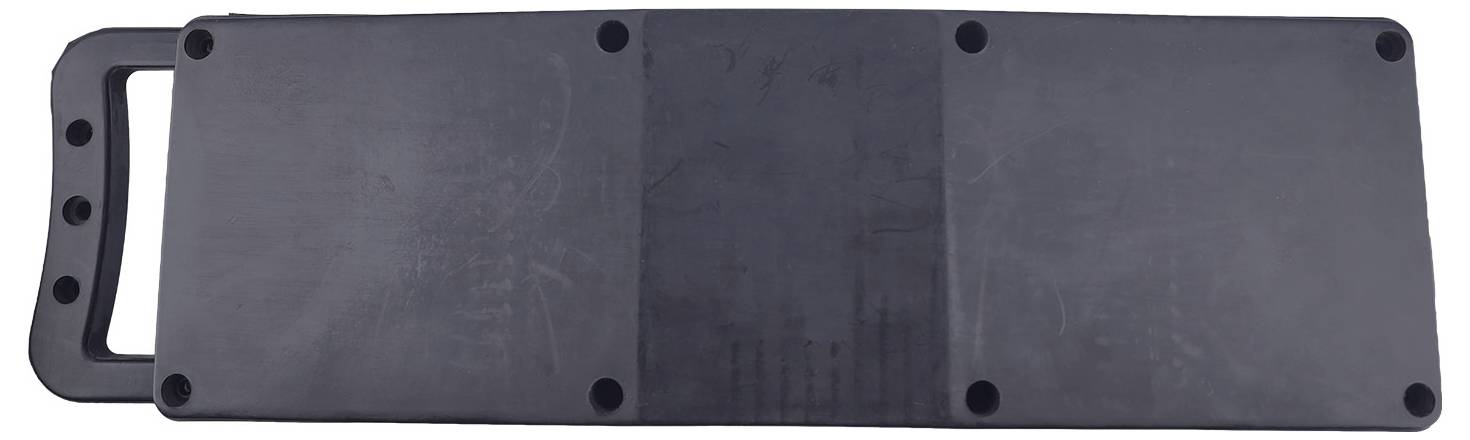 A rectangular, flat, black tool with a handle on one side, featuring several small holes along the top edge.