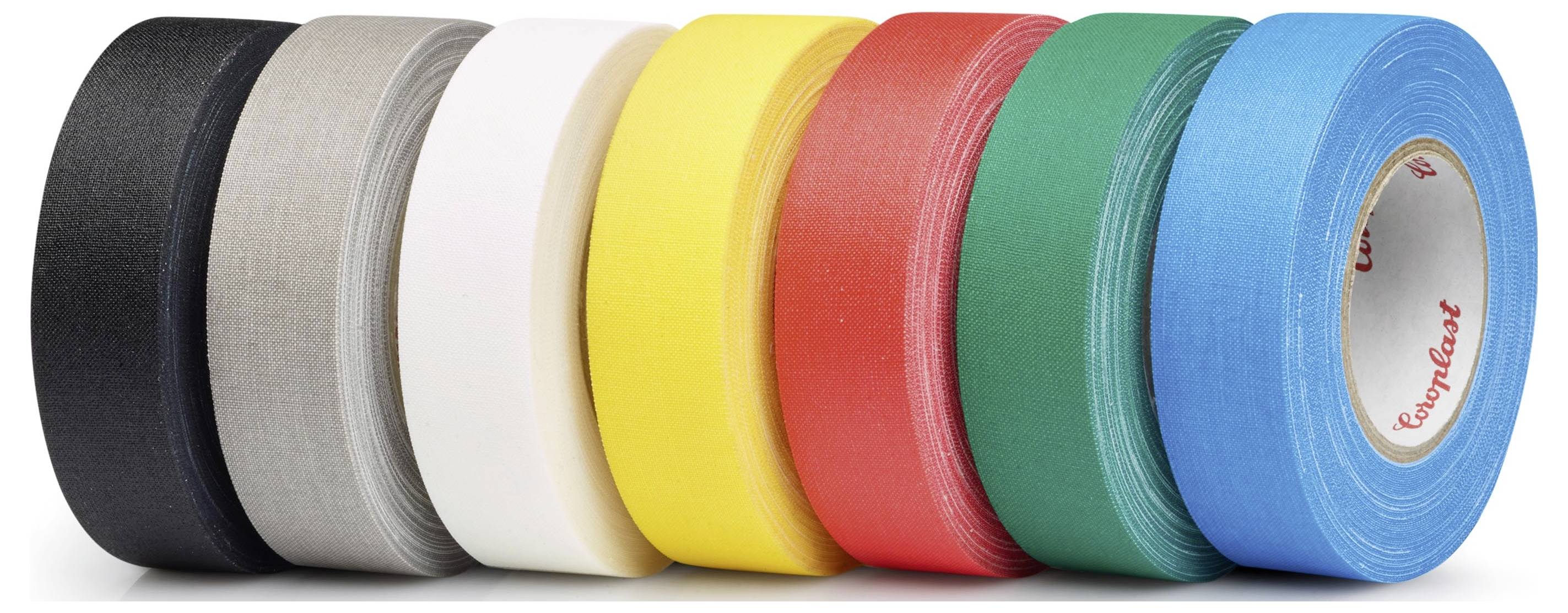Seven rolls of colored tape are lined up: black, gray, white, yellow, red, green, and blue, from left to right.
