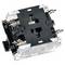 A clear square push button switch unit with internal mechanisms visible, featuring silver and black components and labeled with numbers.