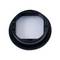 A round black plastic lens cap with a transparent center viewed from above.