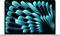 A laptop with an abstract blue and black geometric pattern on the screen, creating a sense of depth and motion.