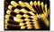 A laptop screen displaying an abstract wallpaper with yellow and black curved shapes radiating from the center.