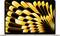A laptop displaying an abstract pattern with bold, wavy stripes in yellow and black, covering the entire screen.