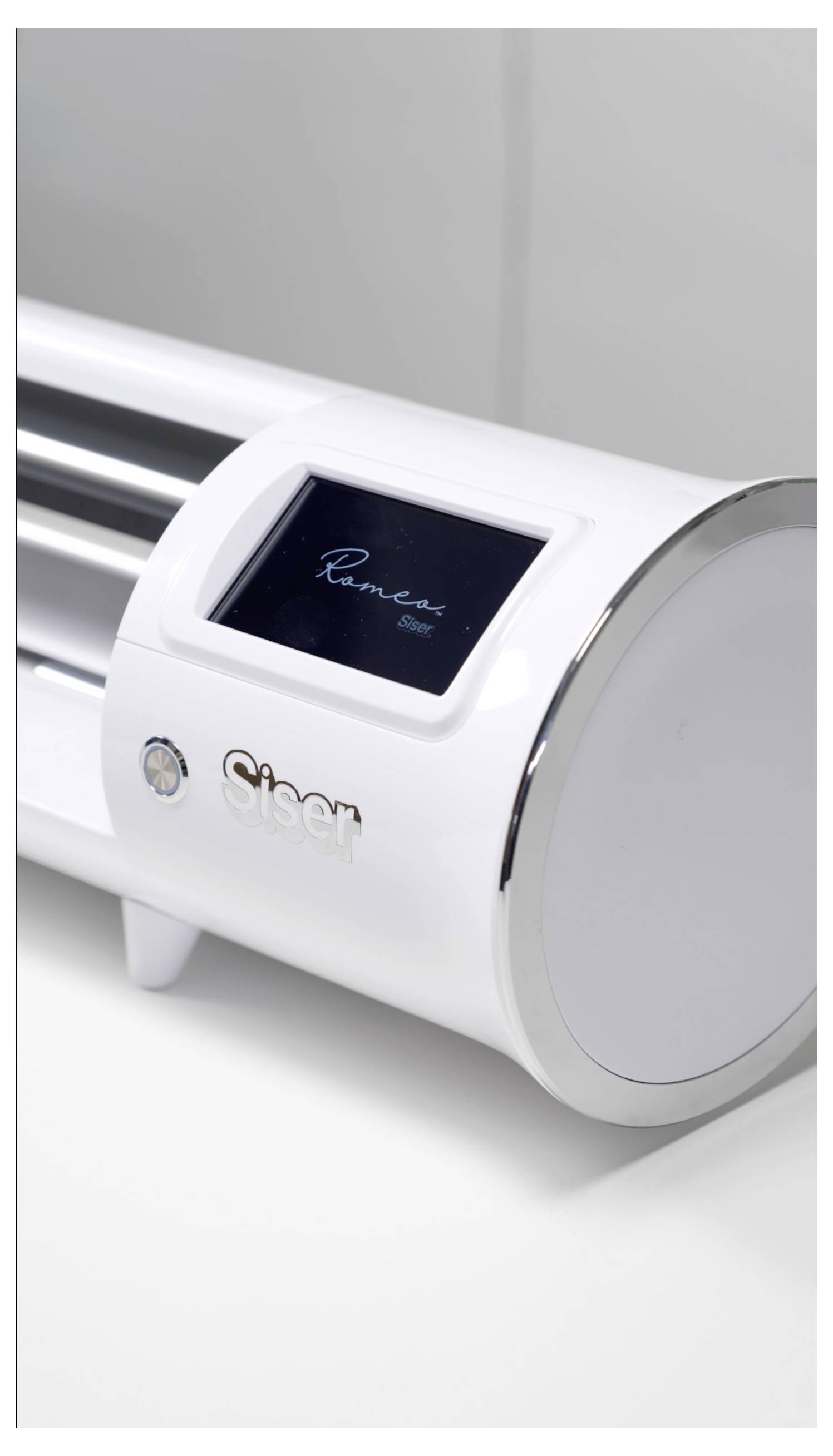 A white electronic cutting machine with a display screen showing 'Romeo'. The brand 'Siser' is visible on the machine.