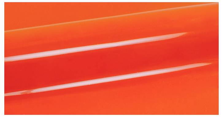 Close-up of a glossy orange surface with two parallel white highlight reflections running diagonally across.