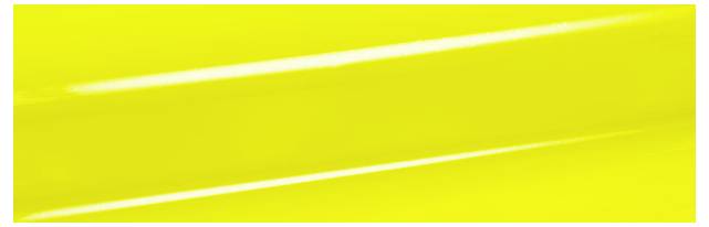 Solid bright yellow background with a glossy finish, reflecting light diagonally across the surface.
