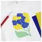 A white fabric with a floral design featuring blue and yellow flowers. A red crafting tool and colored papers are placed nearby.