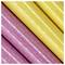 Close-up of glittery pink and yellow pencils arranged diagonally, showing their shiny surface and parallel alignment.