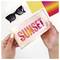 Hands hold a shiny pouch labeled 'SUNSET' with glittery letters; nearby are sunglasses and vibrant color swatches.