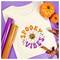 A white t-shirt with the text 'Spooky Vibes' featuring a smiling pumpkin and two skulls, surrounded by orange and purple Halloween decorations.