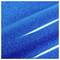 A close-up of a blue glittery surface with a shiny, reflective finish, showing diagonal streaks of light.