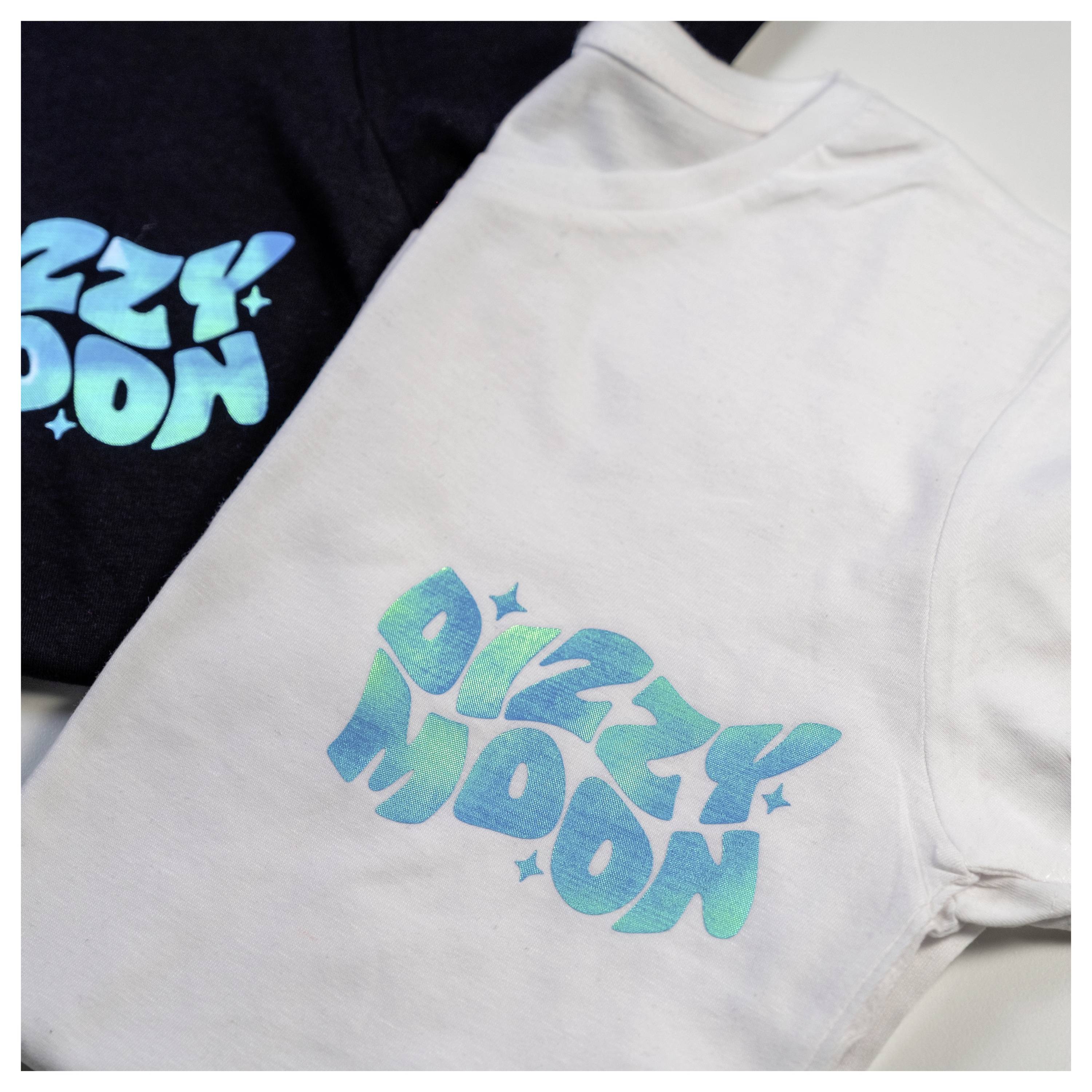 Two T-shirts featuring the text 'Dizzy Moon' in a stylized font with stars, one in black with blue text and another in white with green text.
